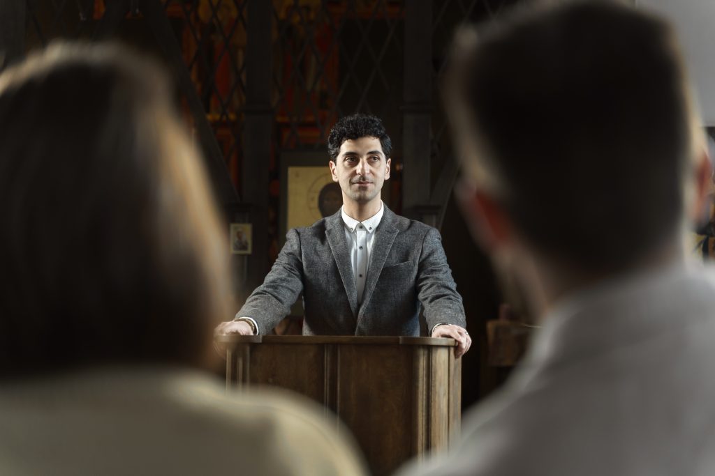 young pastor preaching church